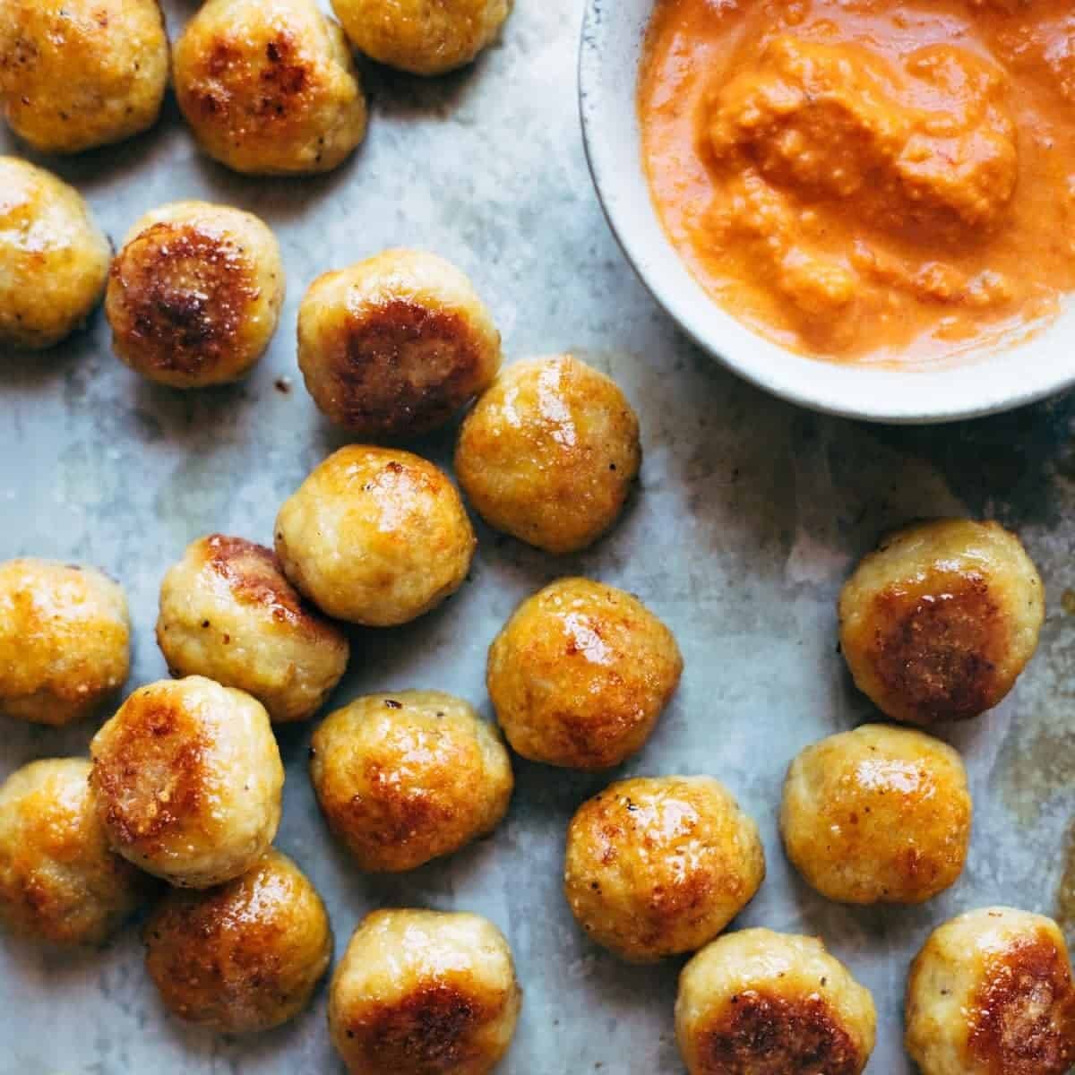 Baked chicken meatballs with romesco sauce.