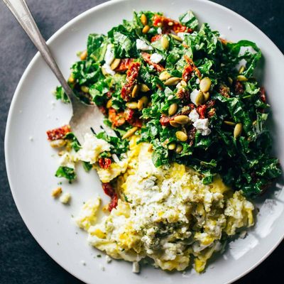 Goat cheese scrambled eggs on a plate.